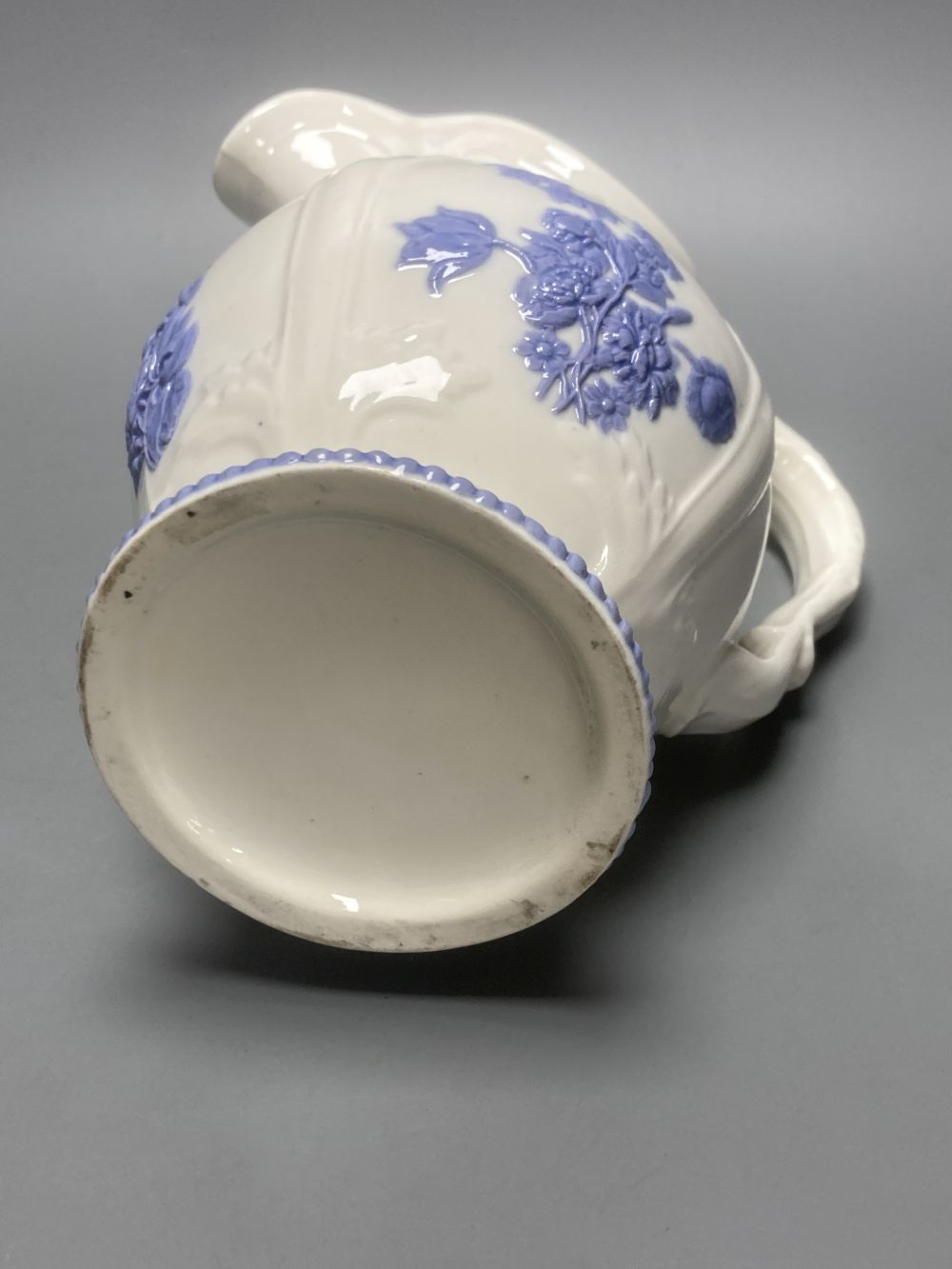 Four early 19th century Staffordshire jugs, each with lilac coloured floral applied panels, one dated 1826, tallest 22cm